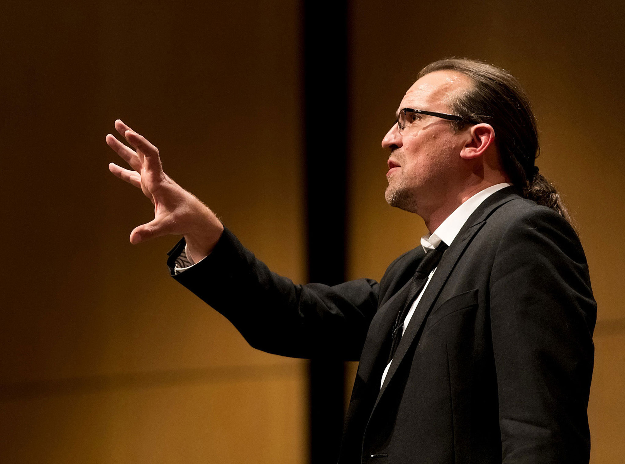 Dave Coplin gesturing mid-speech during a keynote presentation