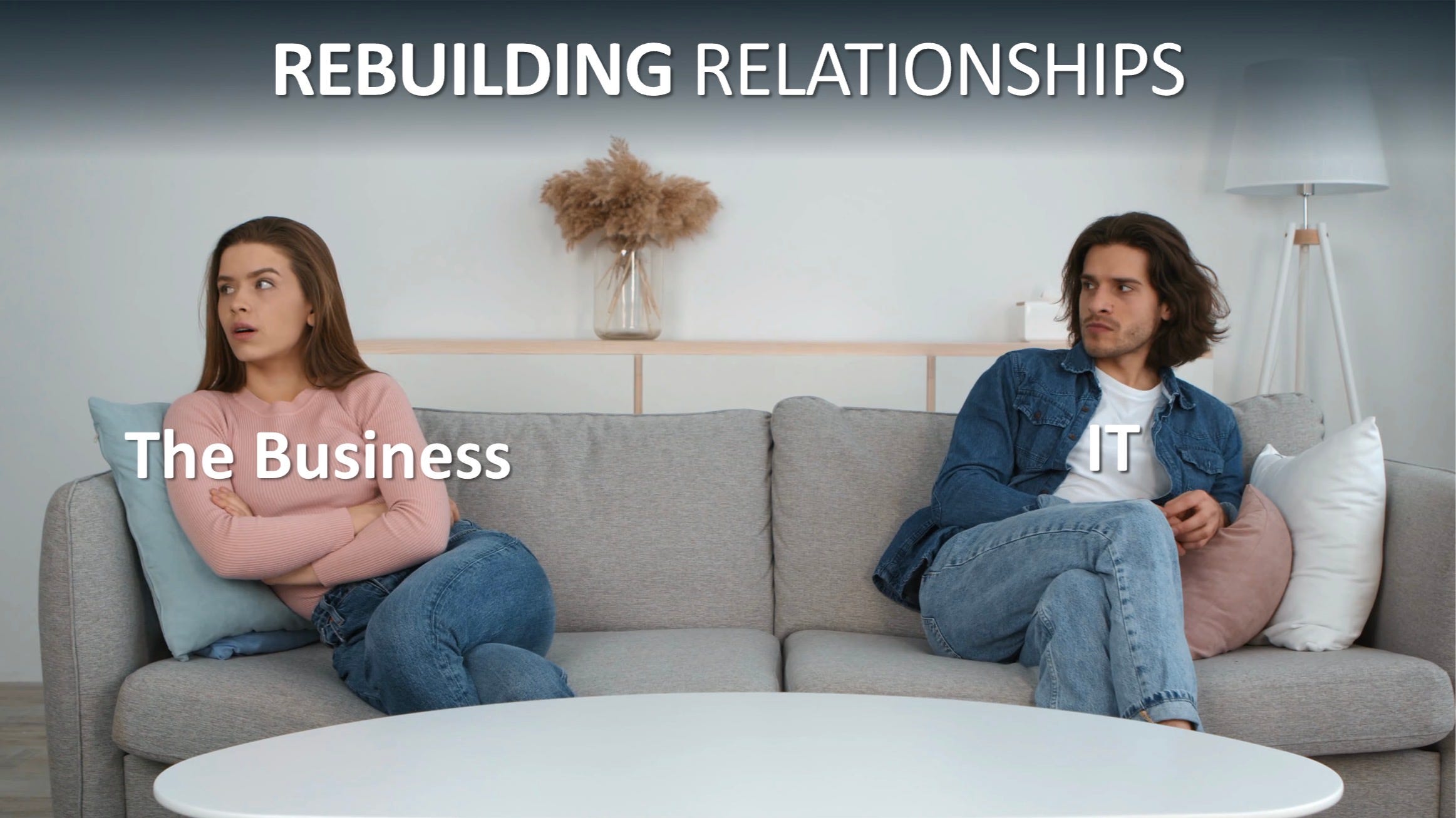 Two people sitting apart on a sofa, arms crossed, not looking at each other. Labelled 'The Business' and 'IT'. Title reads: Rebuilding Relationships.